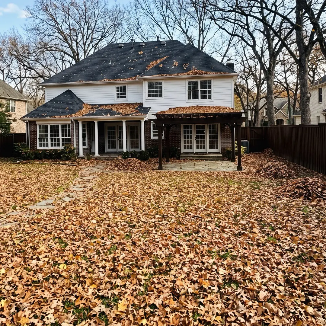 White suburban house with fall leaves in the yard